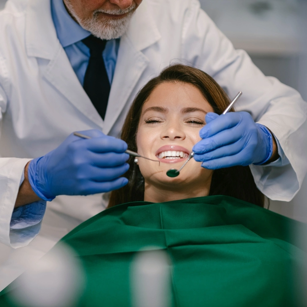 Female patient receiving gentle dental check-up from dentist during oral examination at Hanlon Creek Dental in Guelph