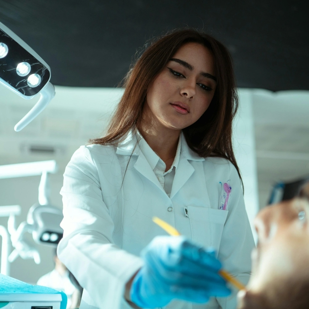 Dentist performing a dental procedure on a patient at Hanlon Creek Dental in Guelph, ON