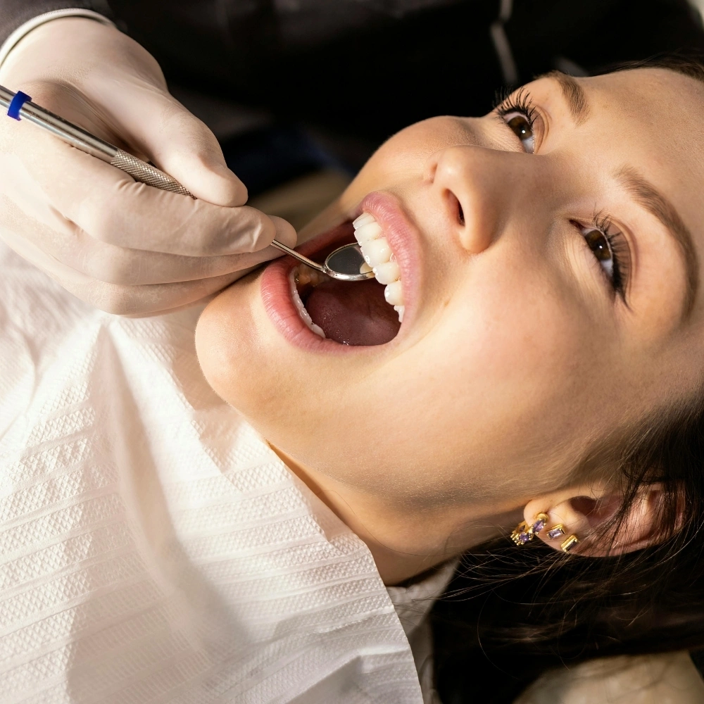 Dentist performing follow-up checkup on patient after dental implant placement at Hanlon Creek Dental in Guelph, ON