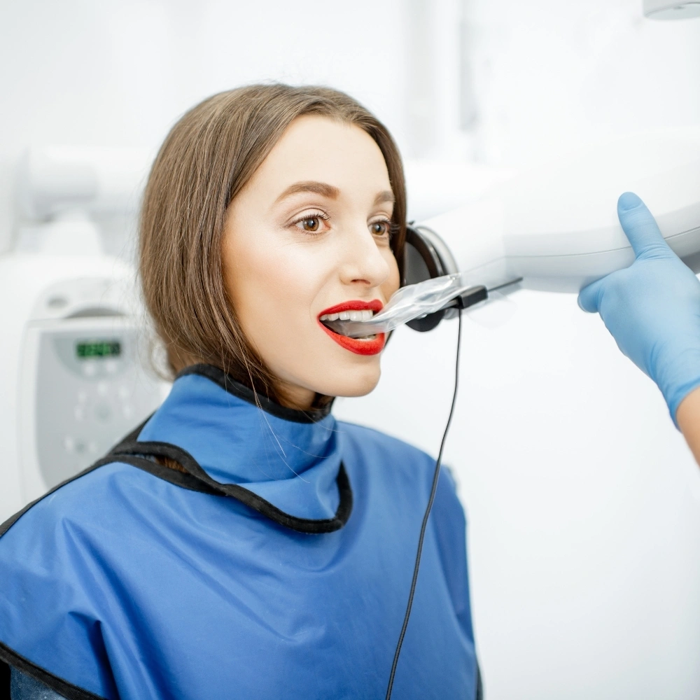 Patient receiving a digital dental X-ray with protective lead apron at Hanlon Creek Dental in Guelph