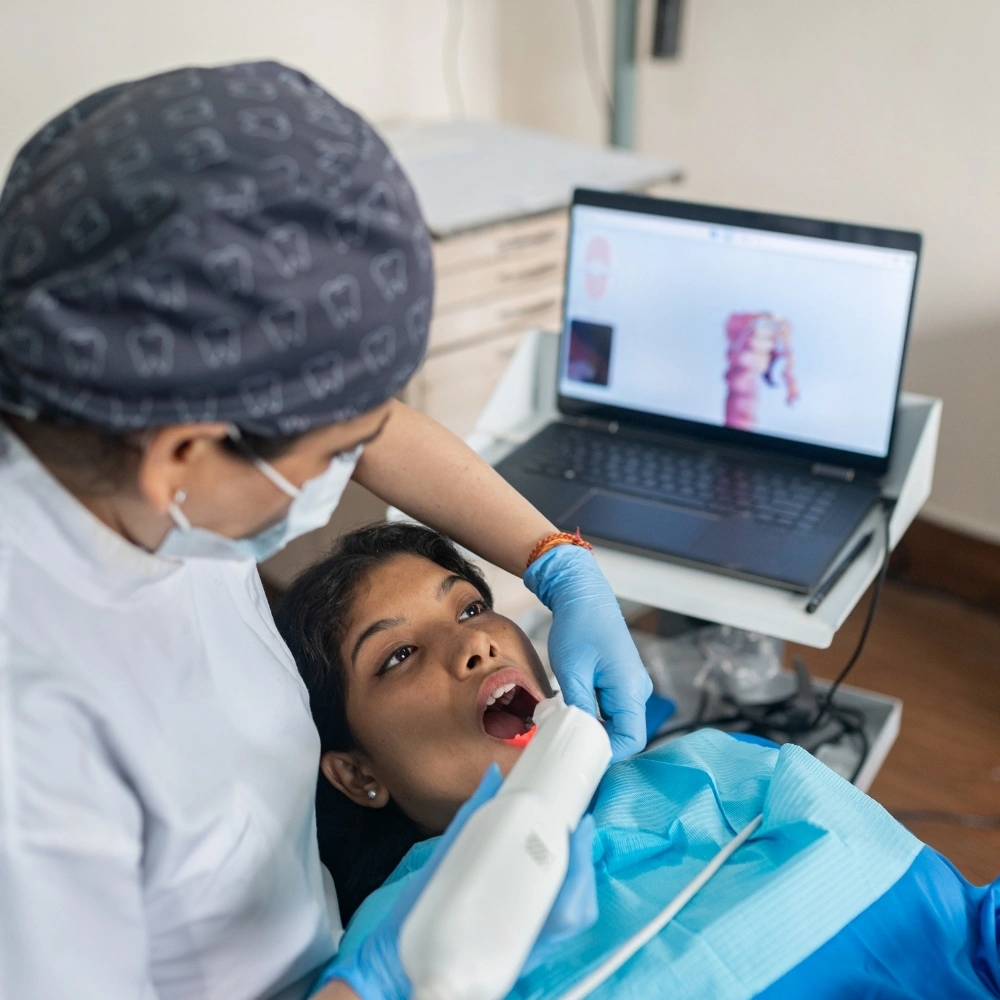 Dentist using a digital intraoral scanner to capture 3D images of a patient’s teeth at Hanlon Creek Dental, Guelph ON